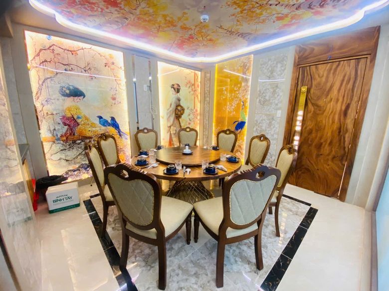 GOLD ONE 小包厢:三面胡姬花与飞鸟发光壁画,八人实木圆桌配转盘,木纹整板包厢门